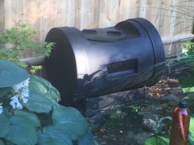 Compost tumbler in garden